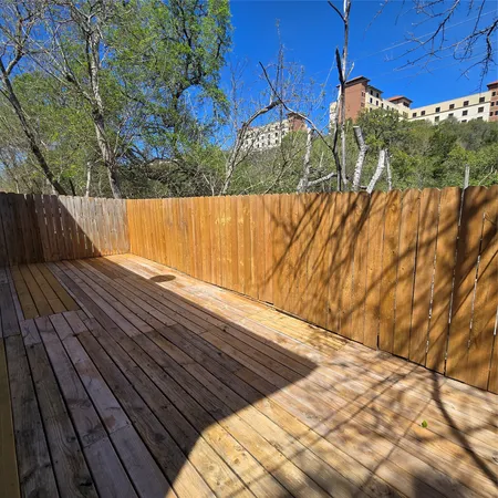 a view of balcony with wooden floor
