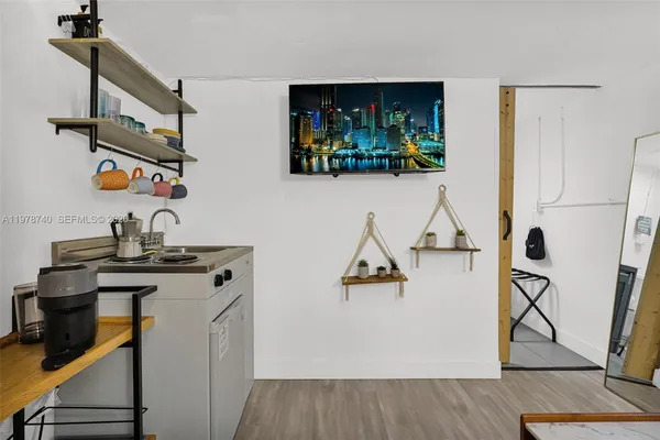 a bed room with a bed and a flat screen tv