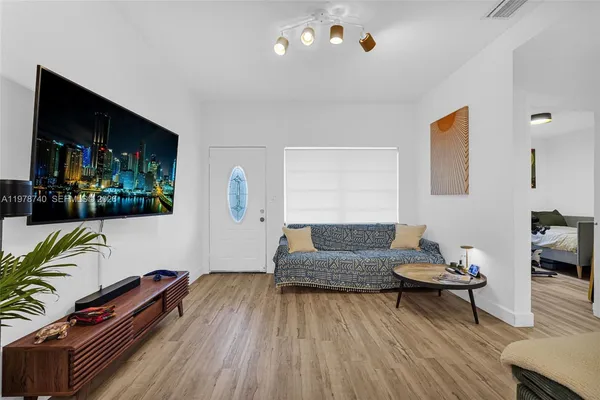 a view of living room with furniture and wooden floor