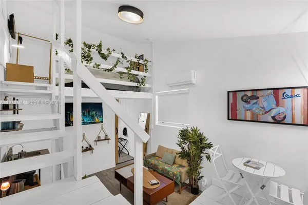 a view of a workspace with furniture and a flat screen tv