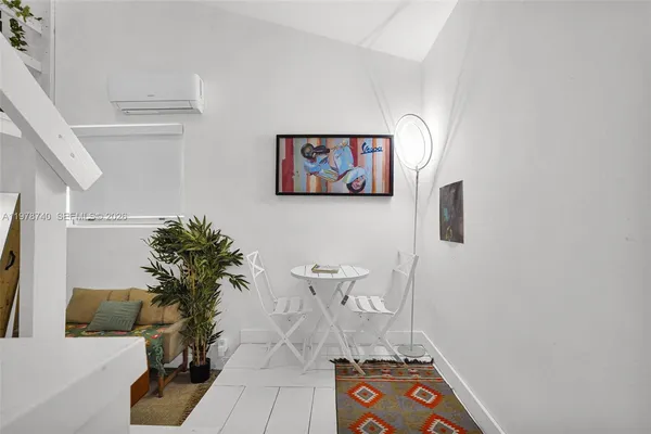 a view of a livingroom with furniture and kitchen