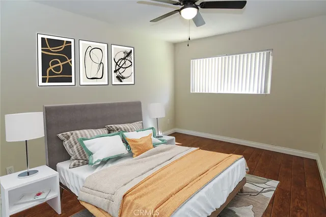 a bedroom with a bed and a lamp on dresser