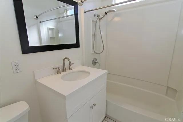 a bathroom with a sink vanity mirror and shower