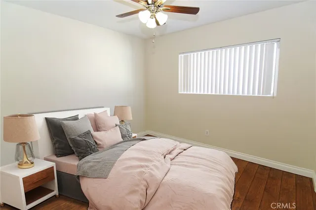 a bedroom with a bed and a ceiling fan