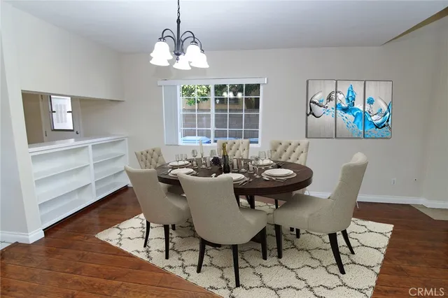 a view of a dining room with furniture wooden floor and a chandelier