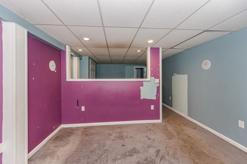 29 Emery Road Townsend, MA 01469 - Photo 20 of 25 a view of a livingroom with a red wall & staircase