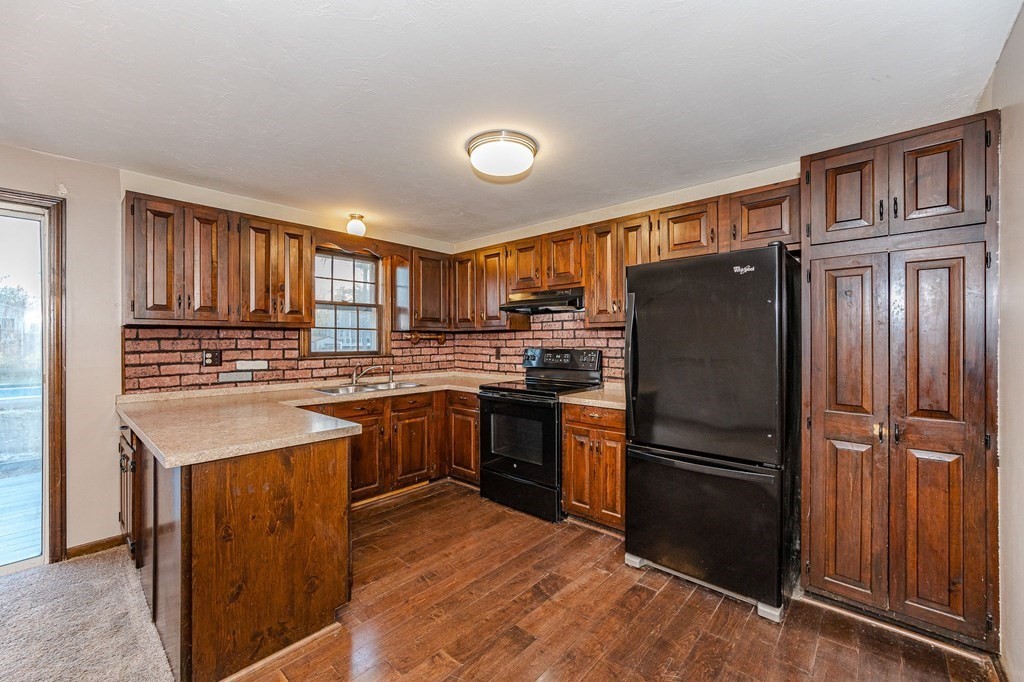 29 Emery Road Townsend, MA 01469 - Photo 3 of 25 a kitchen with granite countertop stainless steel appliances and wooden cabinets