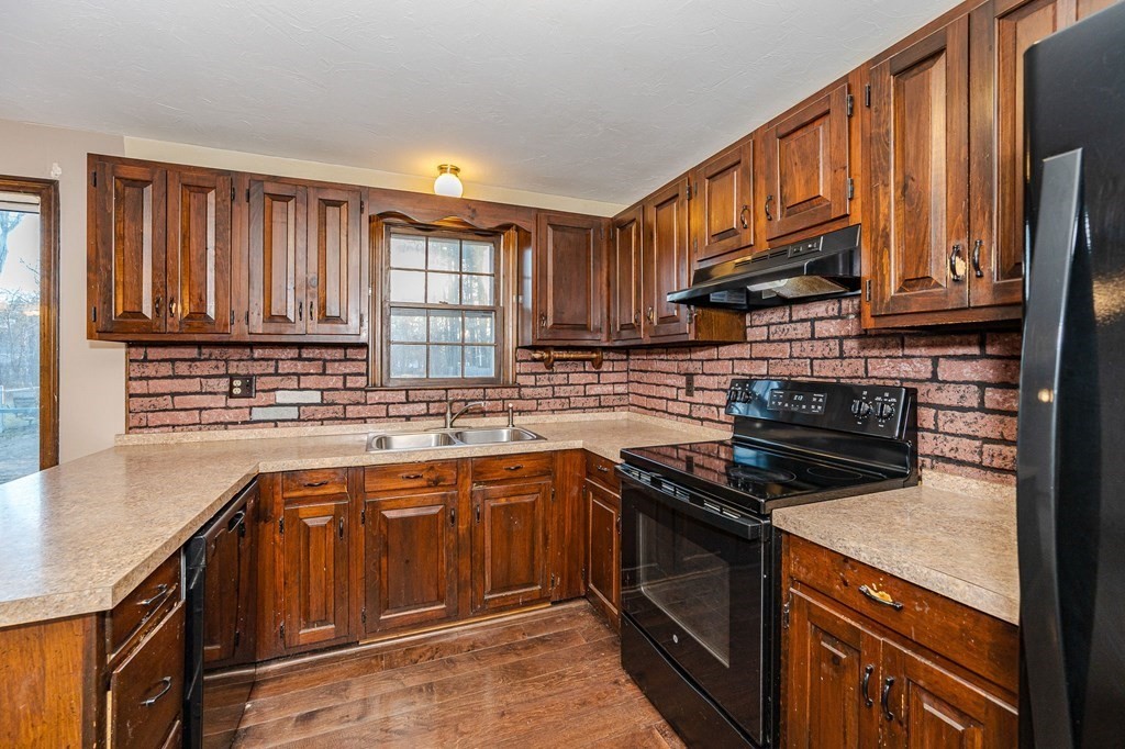 29 Emery Road Townsend, MA 01469 - Photo 4 of 25 a kitchen with stainless steel appliances granite countertop a sink stove and cabinets