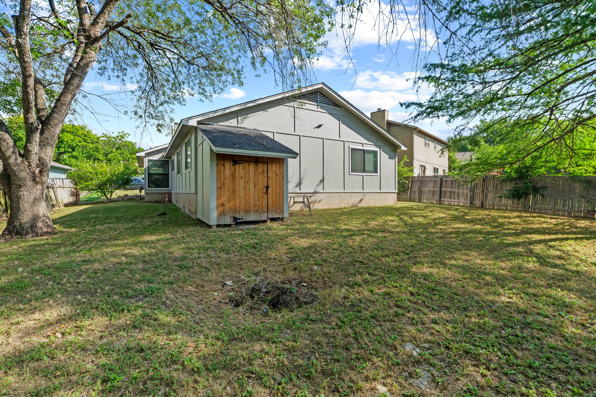 11811 Rotherham Drive Austin, TX 78754 - Photo 31 of 37 A spacious backyard provides ample green space and a quaint storage shed for outdoor essentials.