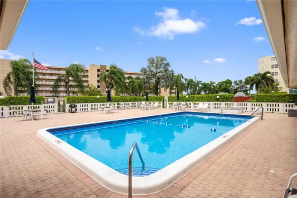 a view of swimming pool with outdoor seating and city view