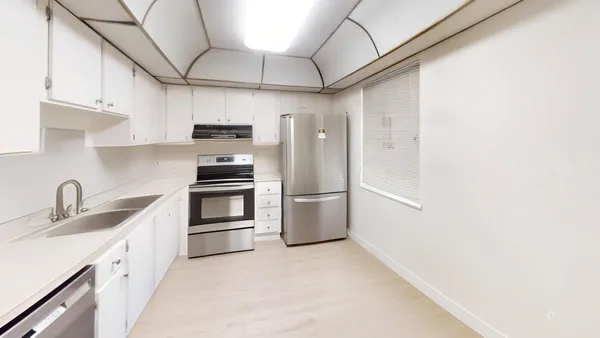a kitchen with stainless steel appliances a refrigerator and a sink