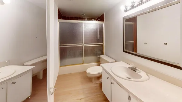 a bathroom with a sink toilet and shower