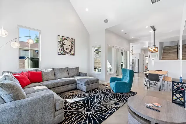 a living room with furniture and wooden floor