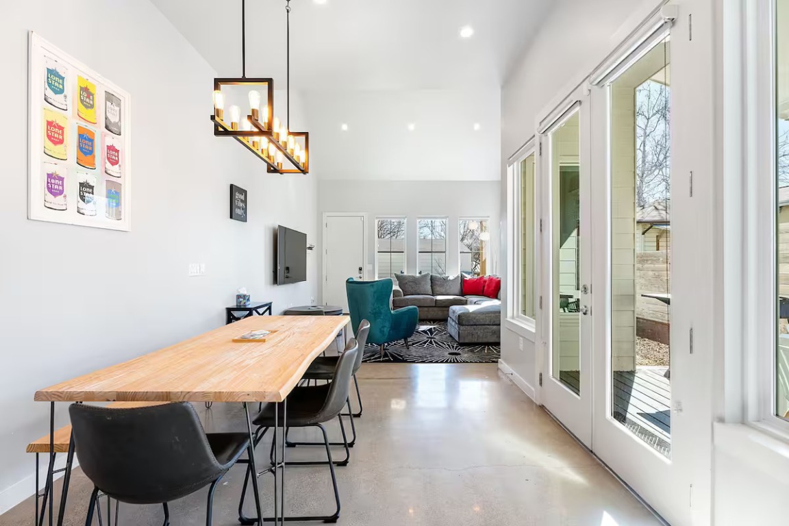 4314 Jinx Avenue, Unit A Austin, TX 78745 - Photo 15 of 40 a view of a dining room with furniture large windows and wooden floor