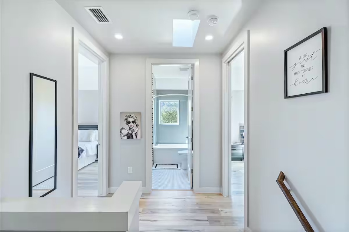 4314 Jinx Avenue, Unit A Austin, TX 78745 - Photo 32 of 40 a view of a hallway with wooden floor and a living room