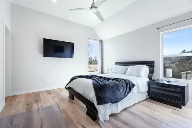 a bedroom with a bed and a flat screen tv