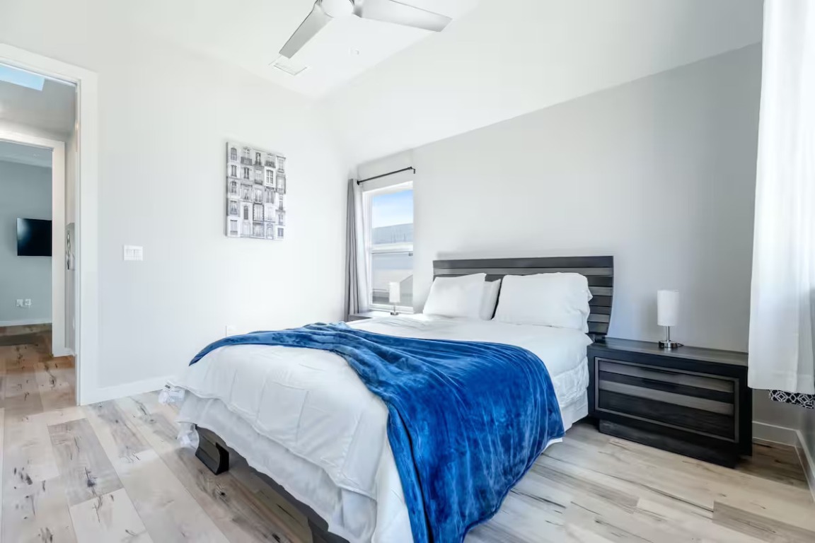 4314 Jinx Avenue, Unit A Austin, TX 78745 - Photo 39 of 40 a bedroom with a bed and wooden floor