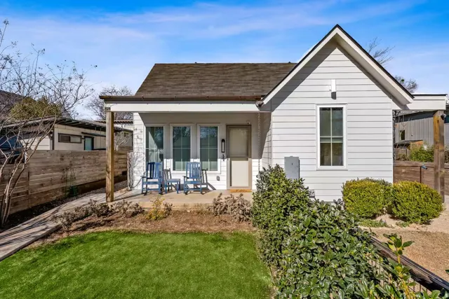 a kitchen with stainless steel appliances granite countertop a refrigerator a stove a oven a sink dishwasher and a refrigerator with wooden floor