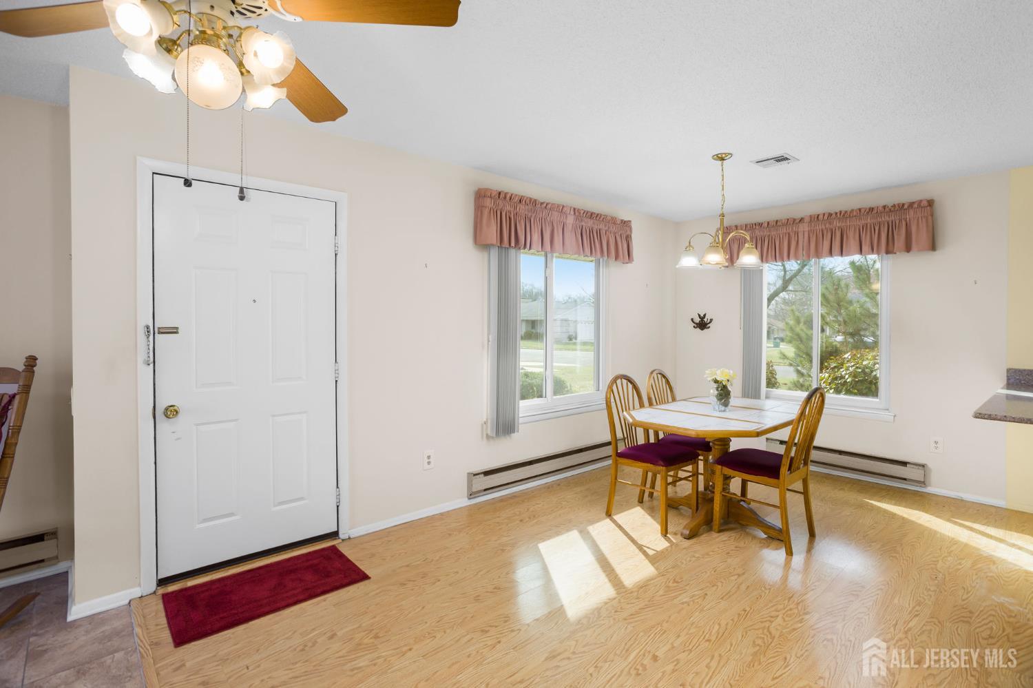 274 Convent Road, Unit D Monroe Township, NJ 08831 - Photo 3 of 12 a view of a dining room with furniture window and outside view