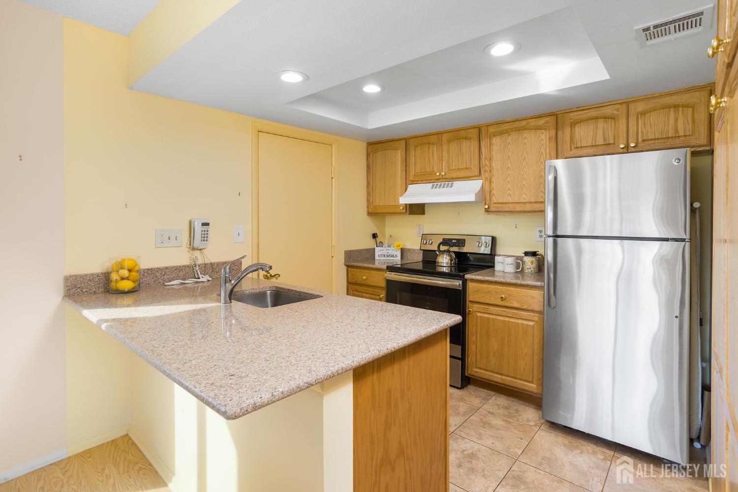 274 Convent Road, Unit D Monroe Township, NJ 08831 - Photo 5 of 12 a kitchen with a sink a refrigerator and a stove