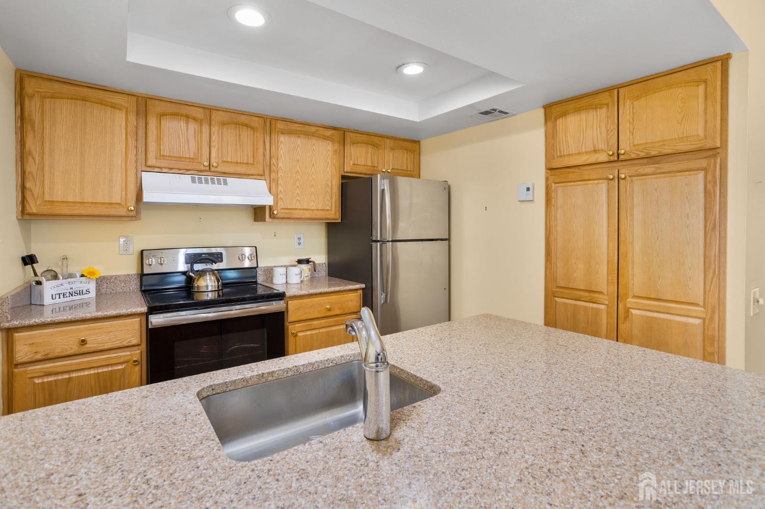 274 Convent Road, Unit D Monroe Township, NJ 08831 - Photo 6 of 12 a kitchen with a refrigerator and a sink