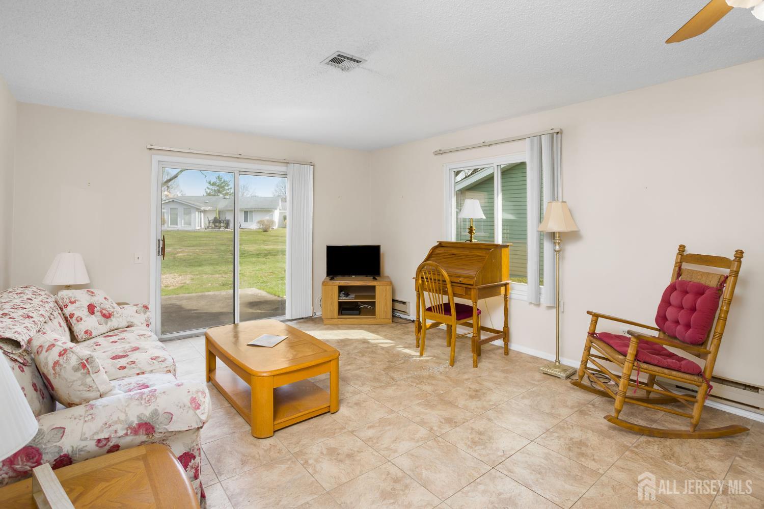274 Convent Road, Unit D Monroe Township, NJ 08831 - Photo 8 of 12 a living room with furniture and a floor to ceiling window