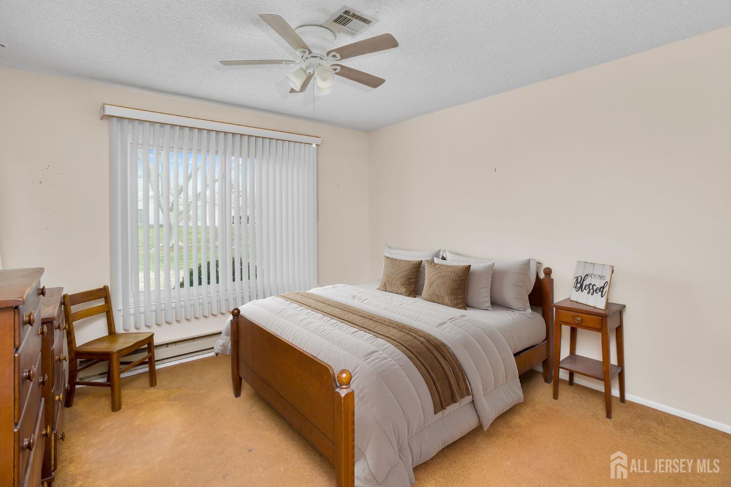 274 Convent Road, Unit D Monroe Township, NJ 08831 - Photo 10 of 12 a bedroom with a bed a chair and a large window