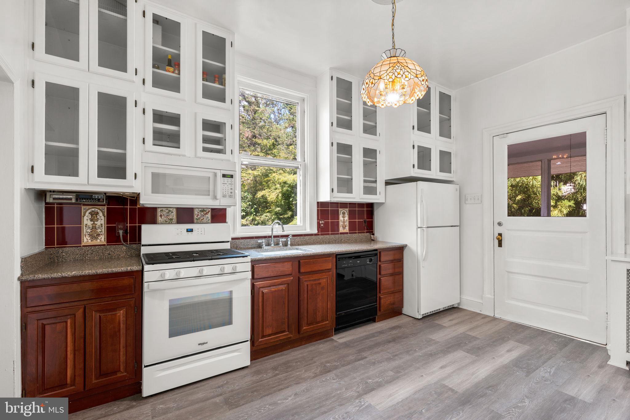 100 North Rolling Road Baltimore, MD 21228 - Photo 21 of 74 a kitchen with stainless steel appliances granite countertop a stove and a sink