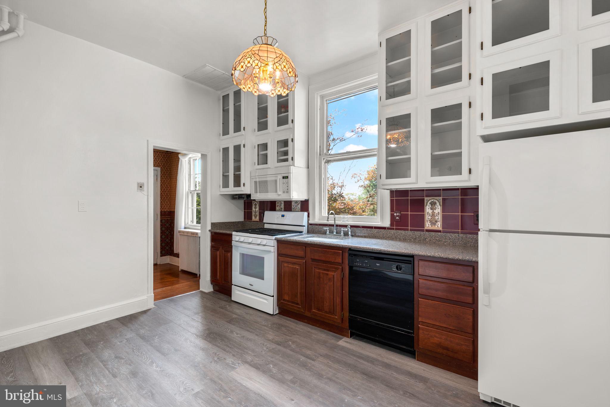 100 North Rolling Road Baltimore, MD 21228 - Photo 24 of 74 a kitchen with stainless steel appliances granite countertop a stove and a refrigerator