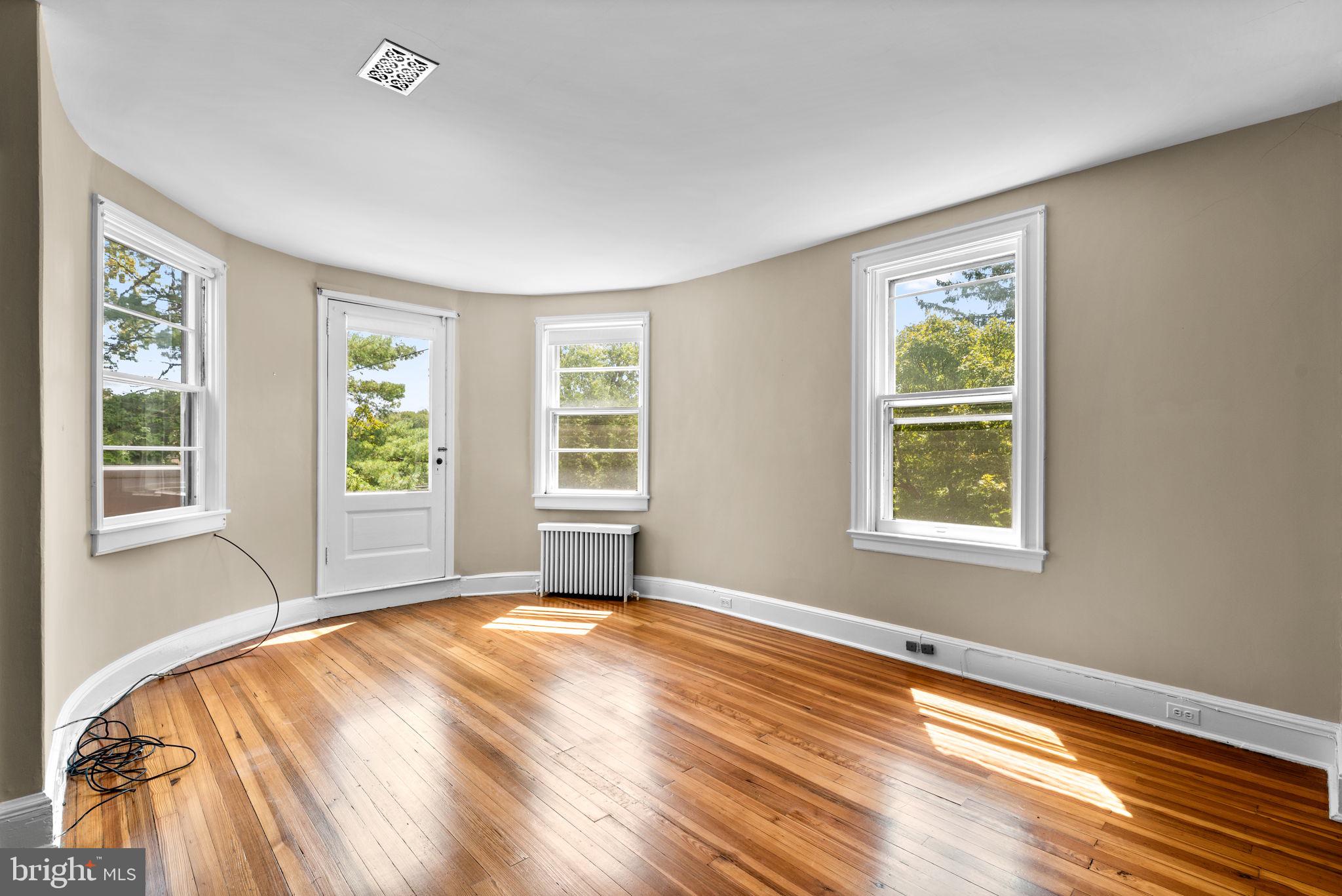 100 North Rolling Road Baltimore, MD 21228 - Photo 31 of 74 a view of a bedroom with wooden floor and a window