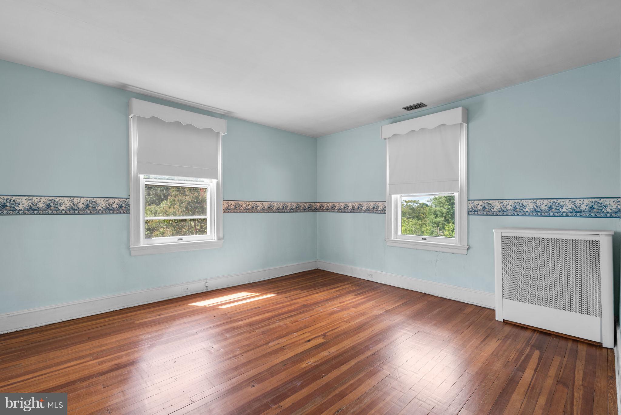 100 North Rolling Road Baltimore, MD 21228 - Photo 34 of 74 an empty room with wooden floor and windows
