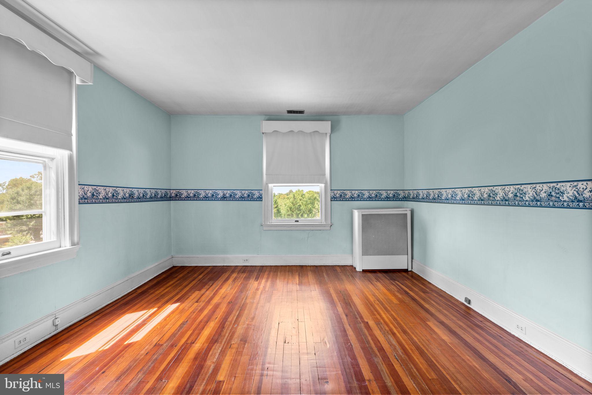 100 North Rolling Road Baltimore, MD 21228 - Photo 35 of 74 a view of empty room with wooden floor and fan