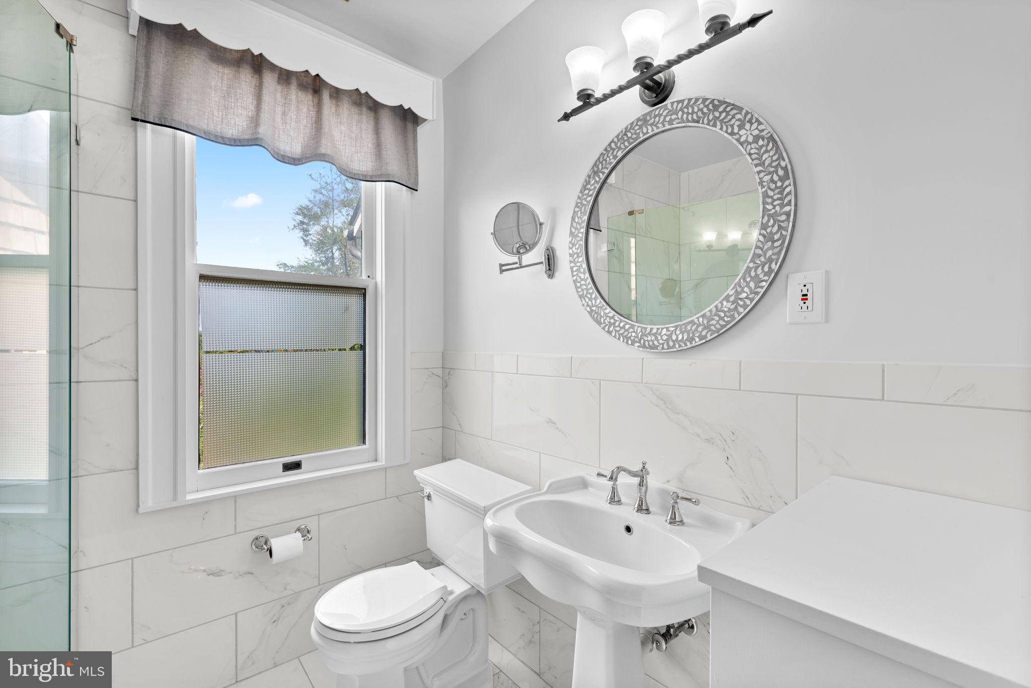 100 North Rolling Road Baltimore, MD 21228 - Photo 37 of 74 a bathroom with a sink and a mirror