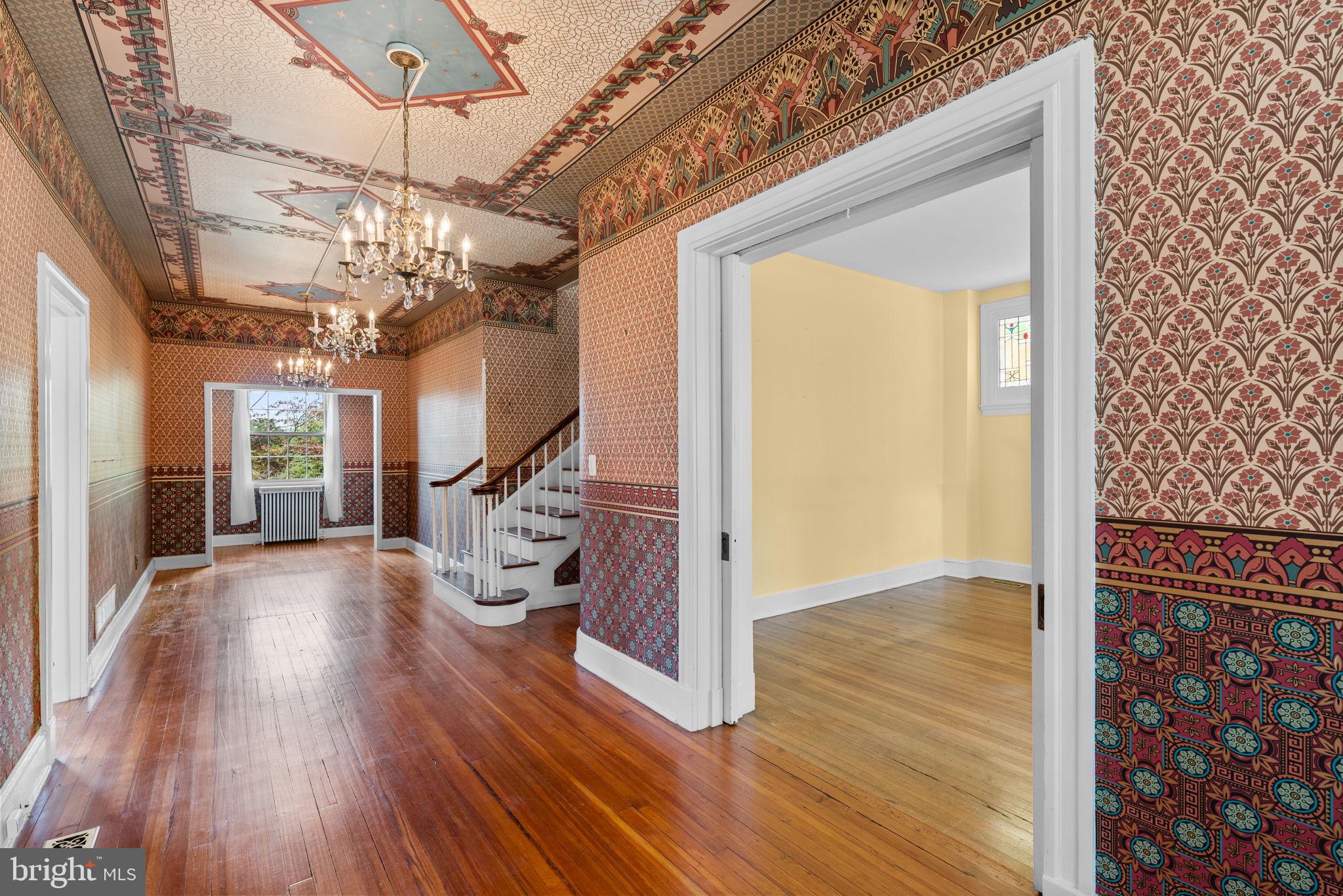 100 North Rolling Road Baltimore, MD 21228 - Photo 8 of 74 a view of a livingroom with wooden floor and stairs