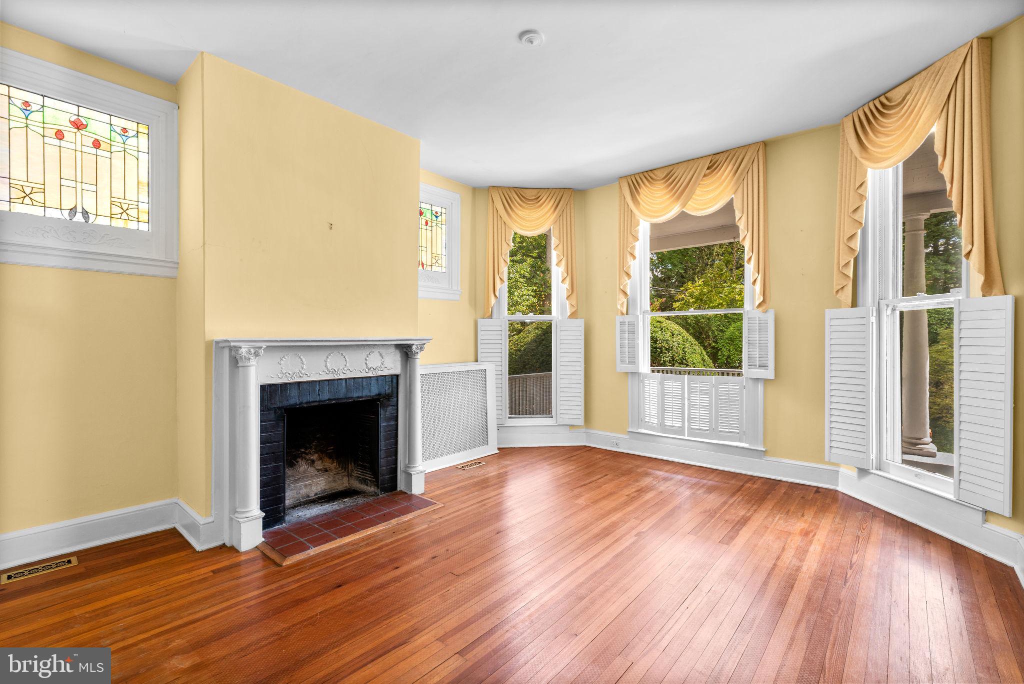 100 North Rolling Road Baltimore, MD 21228 - Photo 10 of 74 a view of an empty room with wooden floor and a window