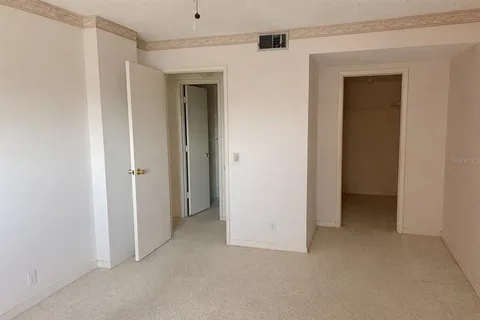 an empty room that has a mirror in it