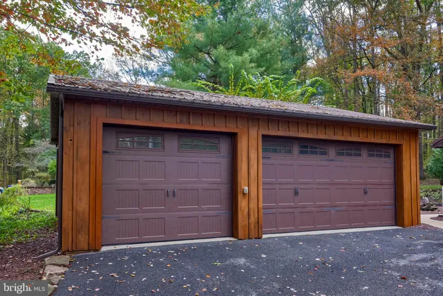 a living room with furniture a flat screen tv and kitchen view