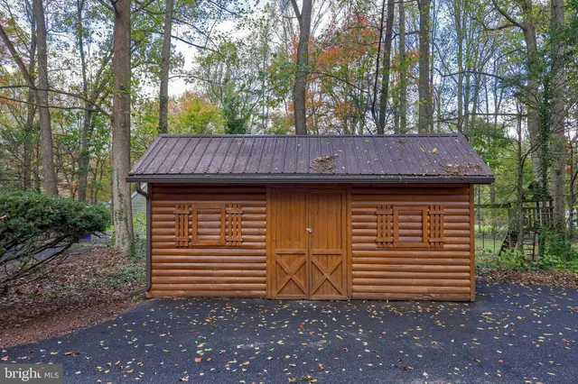 a kitchen with stainless steel appliances granite countertop a stove a refrigerator a sink dishwasher with a dining table and chairs with wooden floor