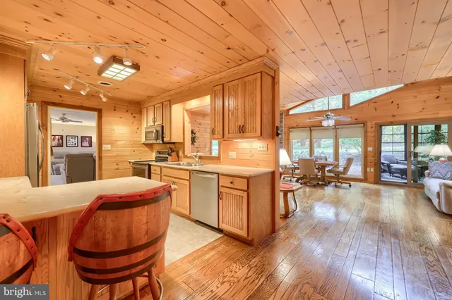 a view of a patio with couches table and chairs and potted plants