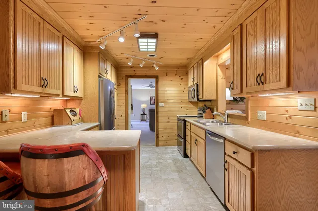a living room with furniture a wooden floor and a large window