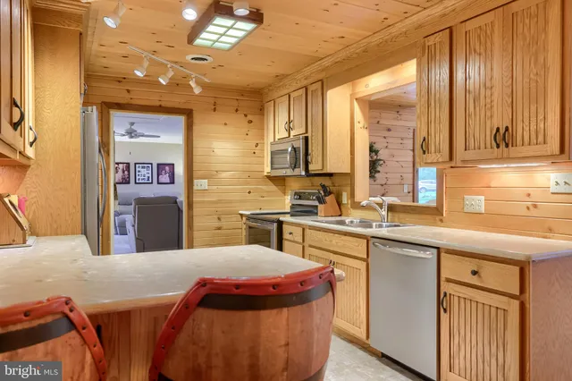 a view of a livingroom with lounge chair and a large window