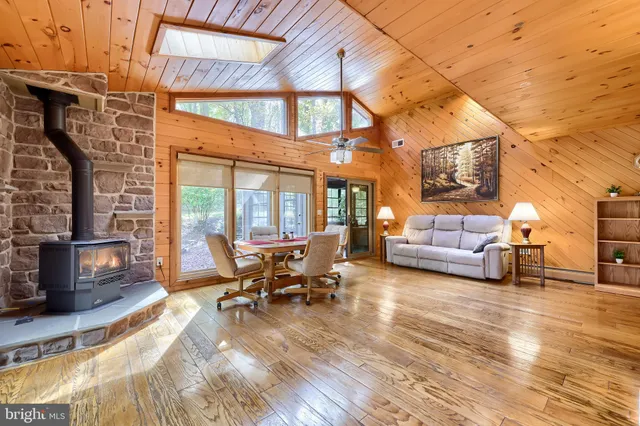 a living room with a fireplace and a floor to ceiling window