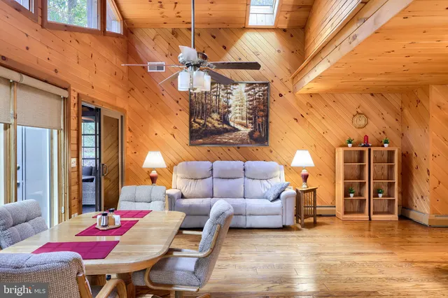 a bedroom with a bed a lamp and a large window