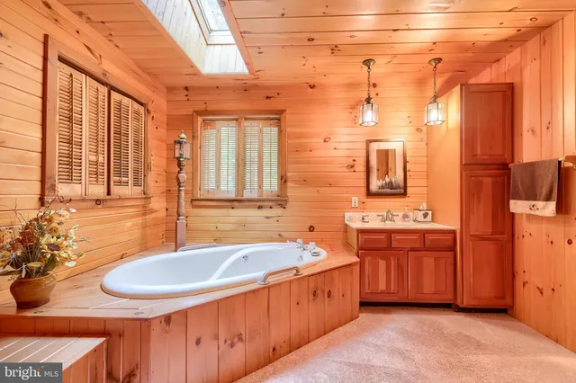 a living room with furniture a ceiling fan and a large window