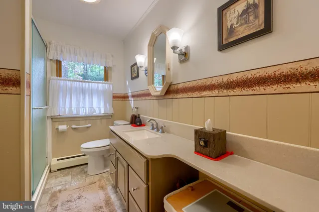 a living room with furniture and a ceiling fan