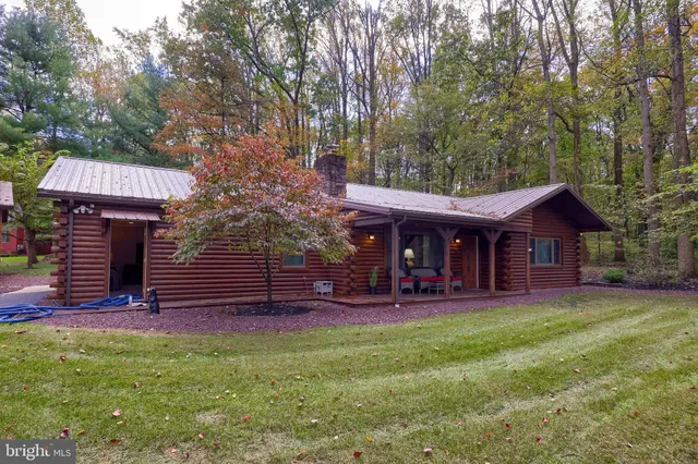 a view of a house with a tree in the yard