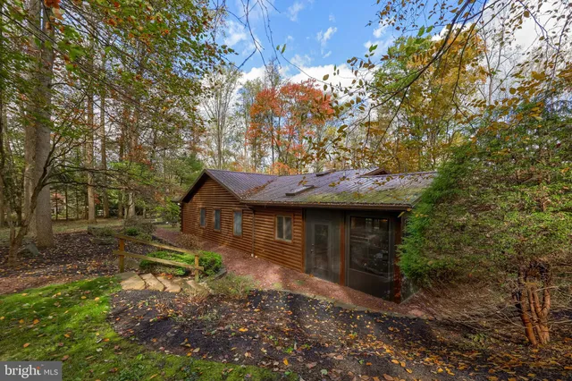 a view of backyard with table and chairs and wooden fence