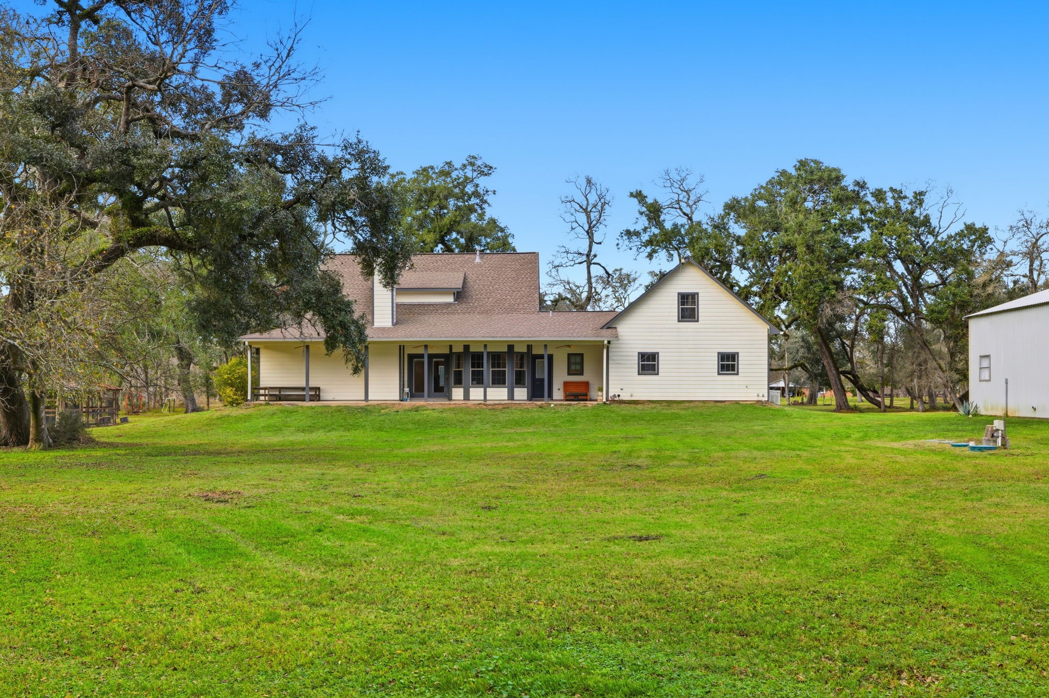 20407 Deer Run Road Damon, TX 77430 - Photo 22 of 29 a view of a big house with a big yard and large trees