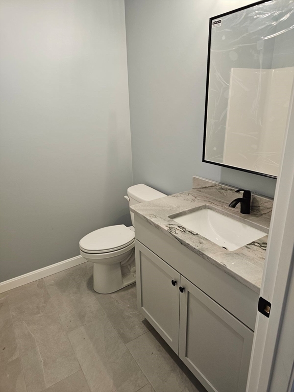 123 Keys Road Warren, MA 01585 - Photo 4 of 12 a bathroom with a granite countertop toilet sink and mirror