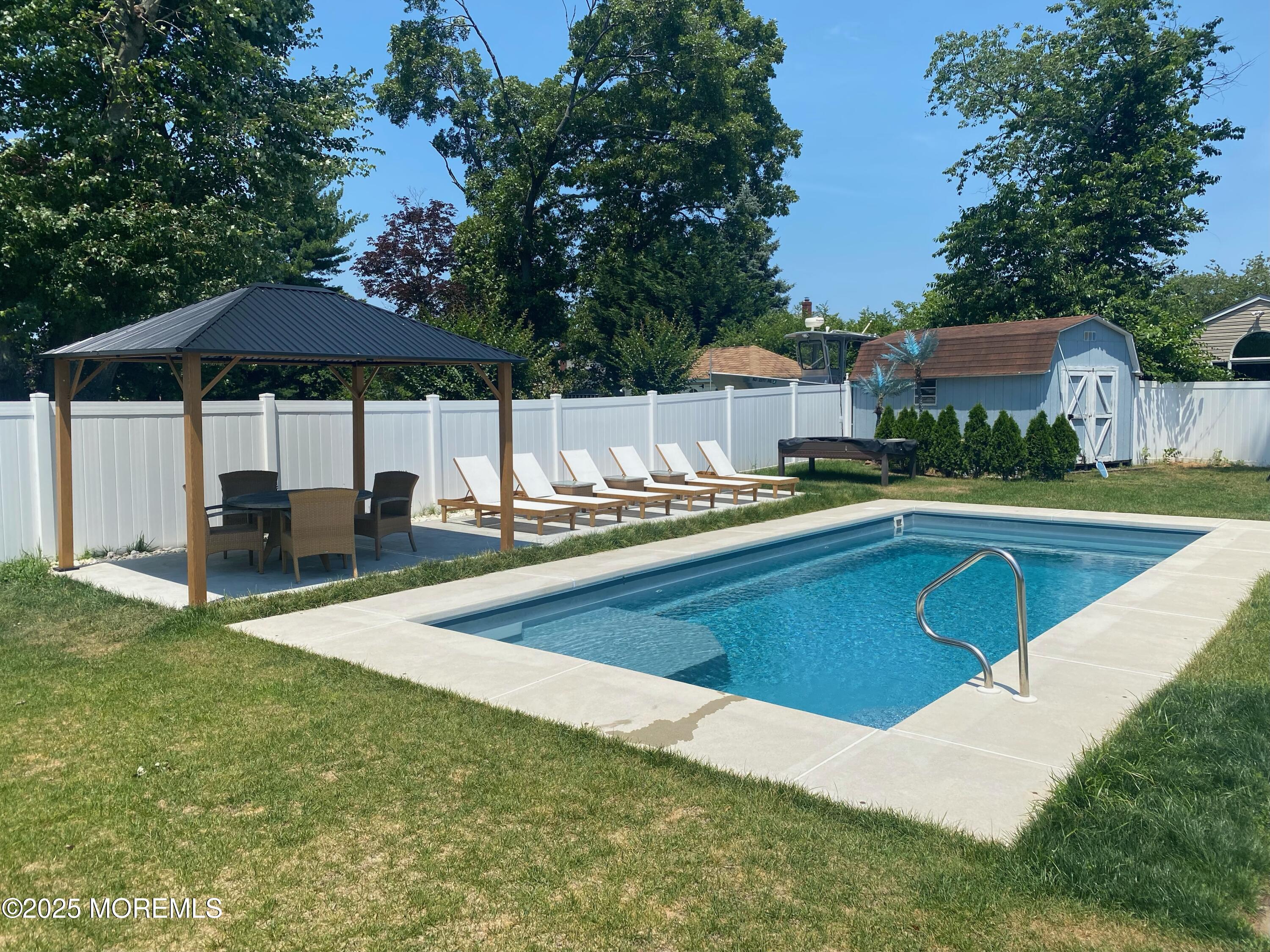 a view of a house with swimming pool and sitting area